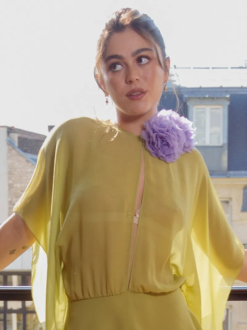 Image may contain Mika Abdalla Blouse Clothing Sleeve Adult Person Face Head Photography and Portrait