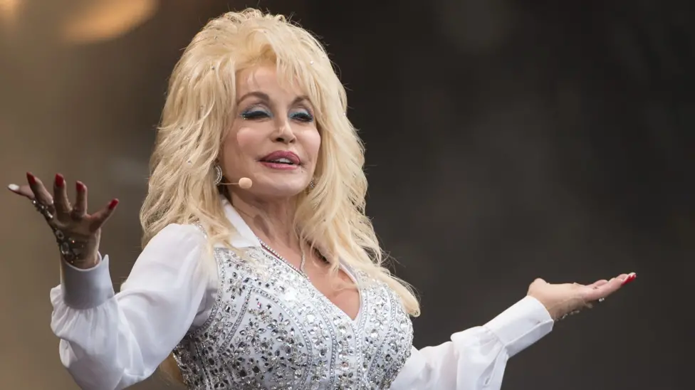 Dolly Parton in a white jewelled outfit