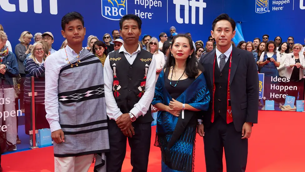 From right: Theja Rio poses with Nancy Nisa Beso, the film's producer, and actors Anglong Konyak (as the village chief, Anghba) and Sobino Rengma (as his son Amao)