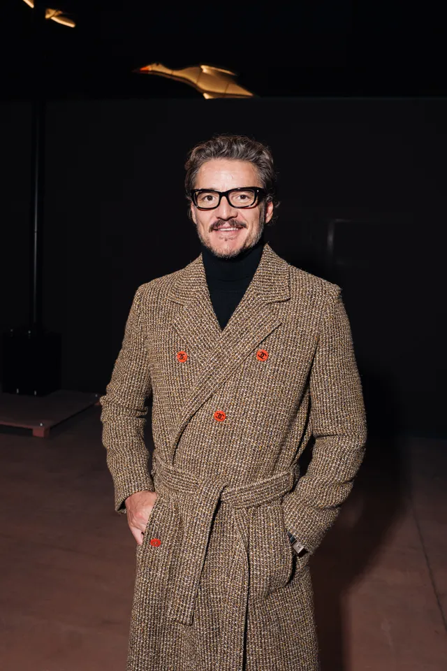 Image may contain Pedro Pascal Clothing Coat Jacket Blazer Face Head Person Photography Portrait and Adult