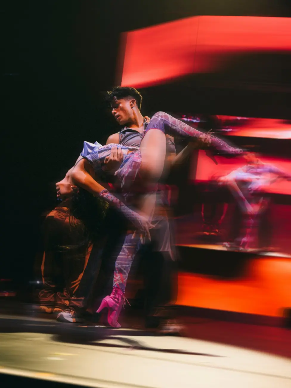 Daniela from Katseye is held by a dancer during the band’s concert in Dublin