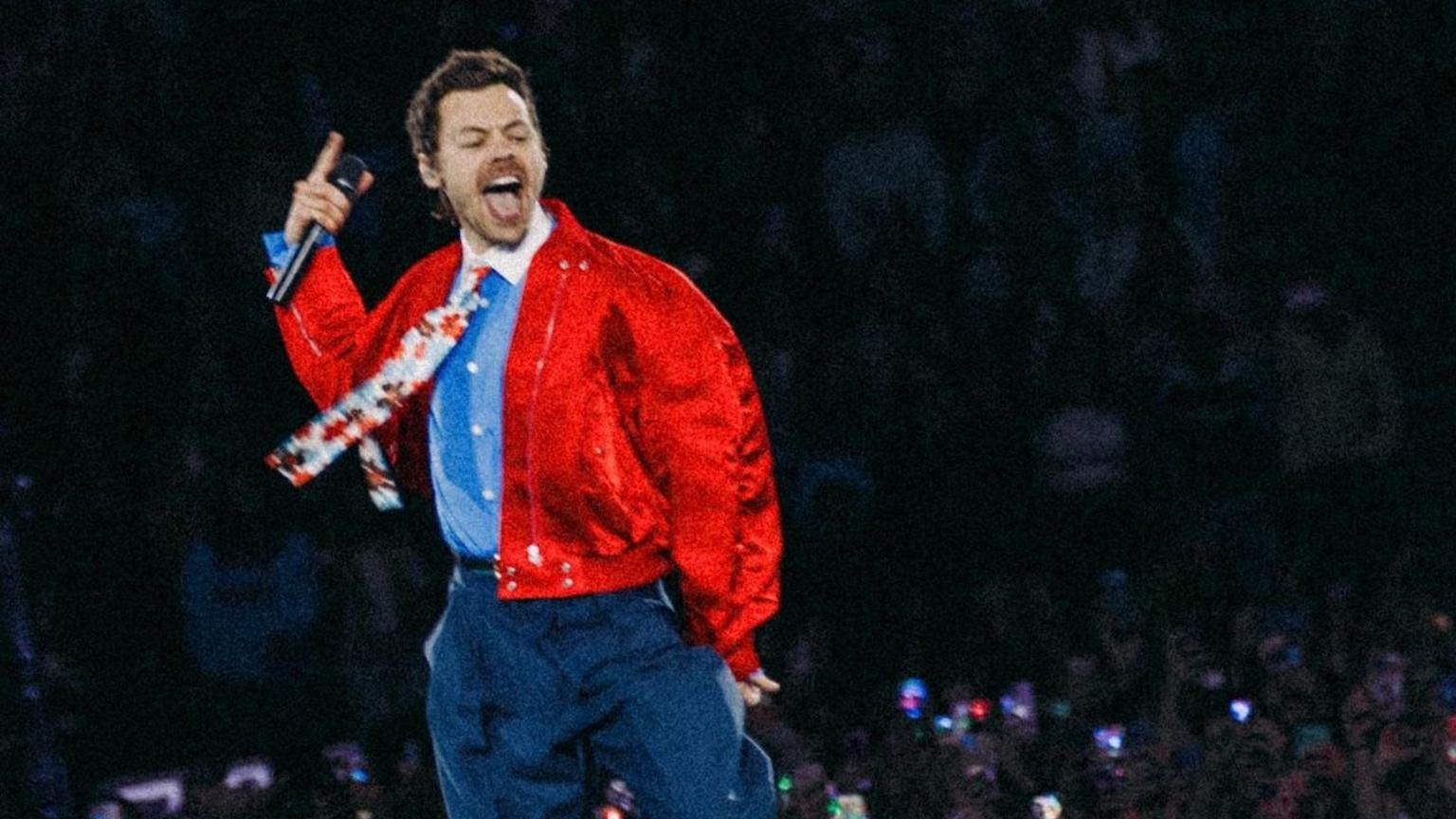 Harry Styles performing live on stage during his tour
