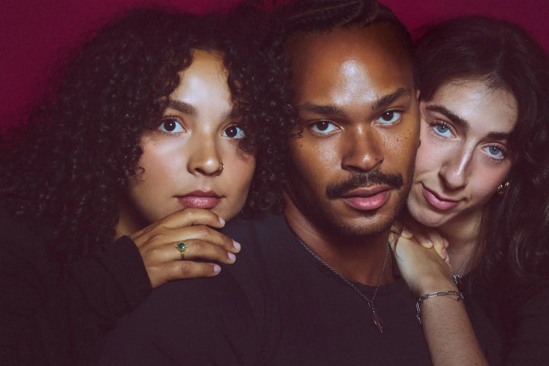 Indie folk pop trio Tiny Habits posing together for a portrait