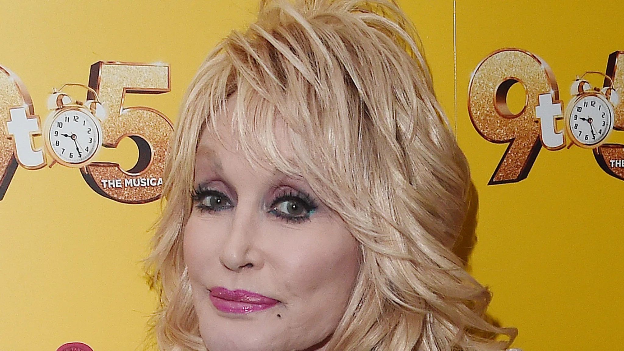 A graphic tribute featuring an uplifting Dolly Parton lyric on a pink background