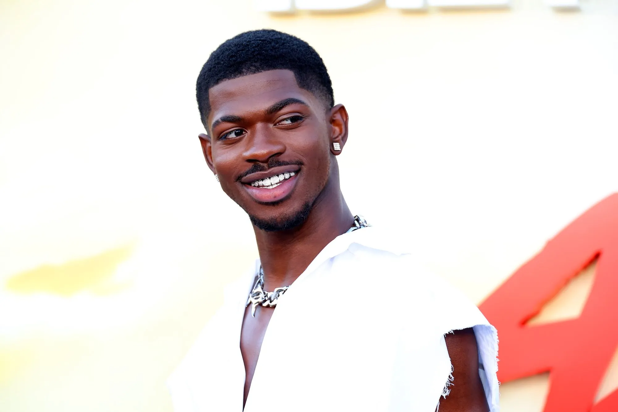 Lil Nas X posing for a social media photo while celebrating a personal life milestone
