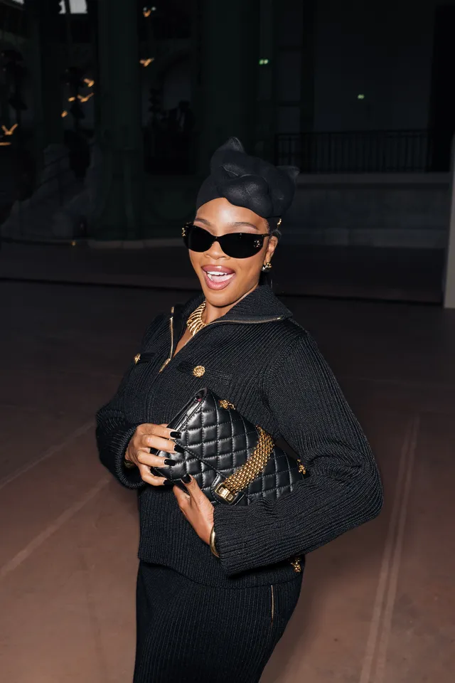 Image may contain Accessories Bag Handbag Sunglasses Adult Person Clothing Coat Jacket Black Hair Hair and Face