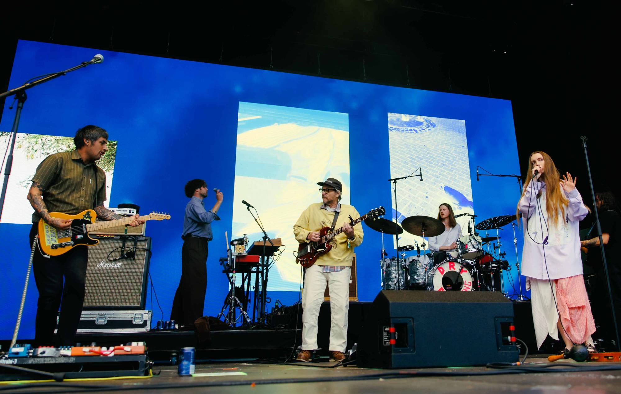 Jeff Tweedy performs on guitar on stage with Dry Cleaning at Green Man Festival