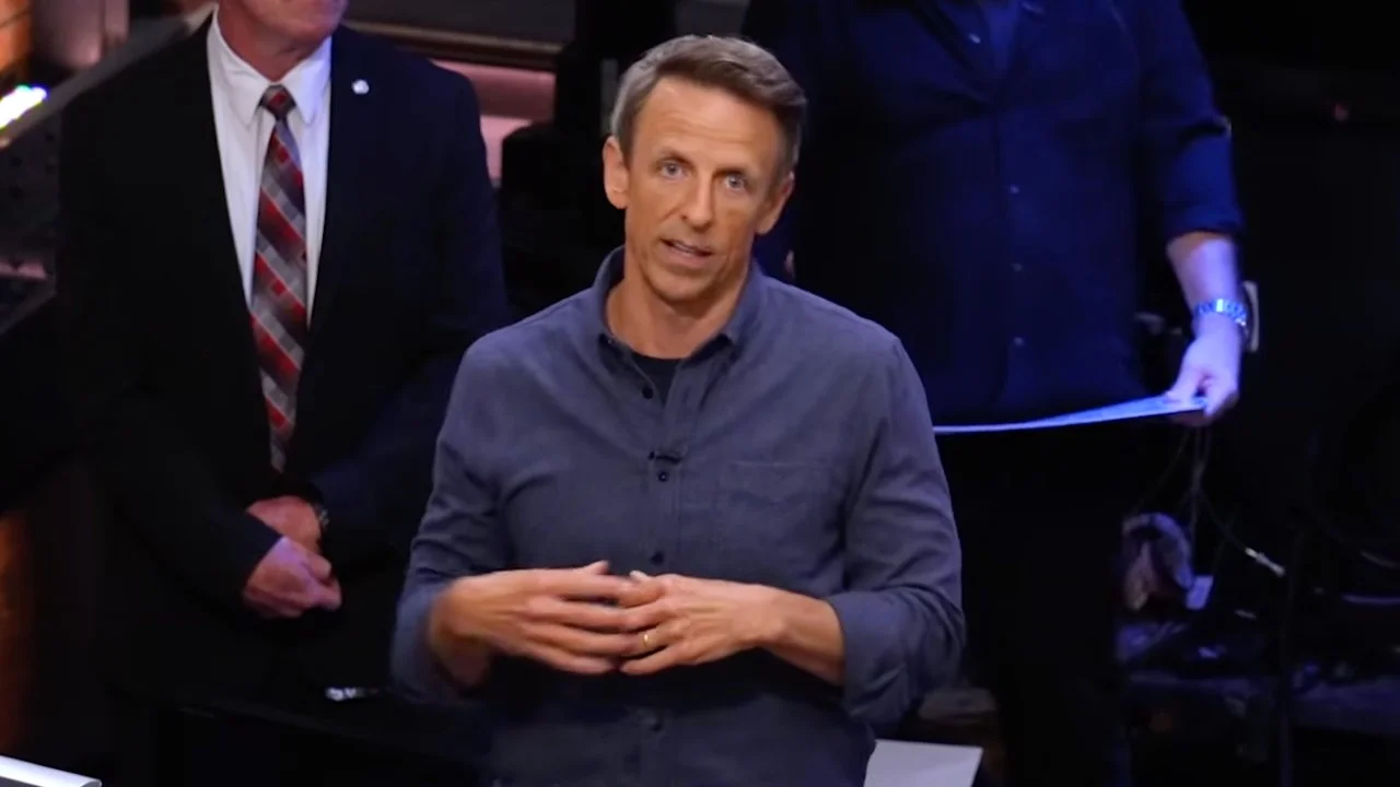 Seth Meyers smiling on the set of Late Night