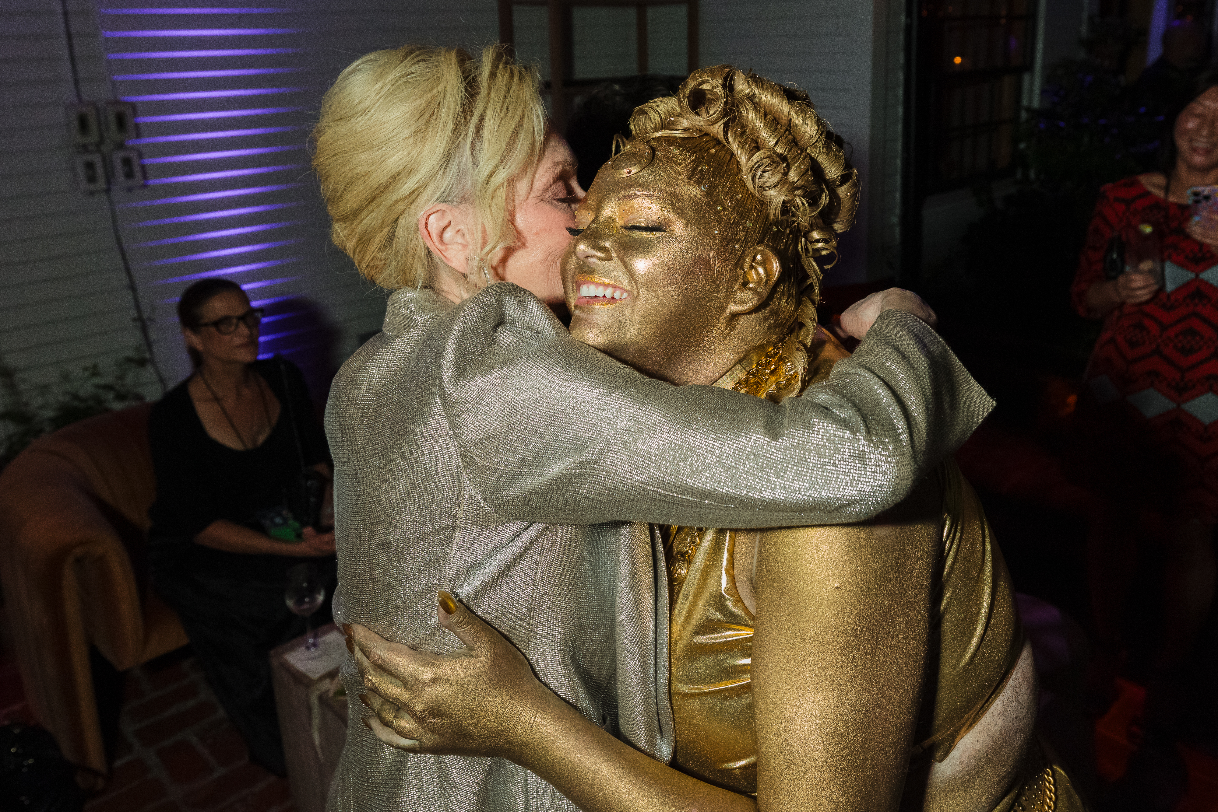 Jean Smart embraces Megan Stalter, who is painted gold, at the HBO Max Primetime Emmy Awards afterparty.