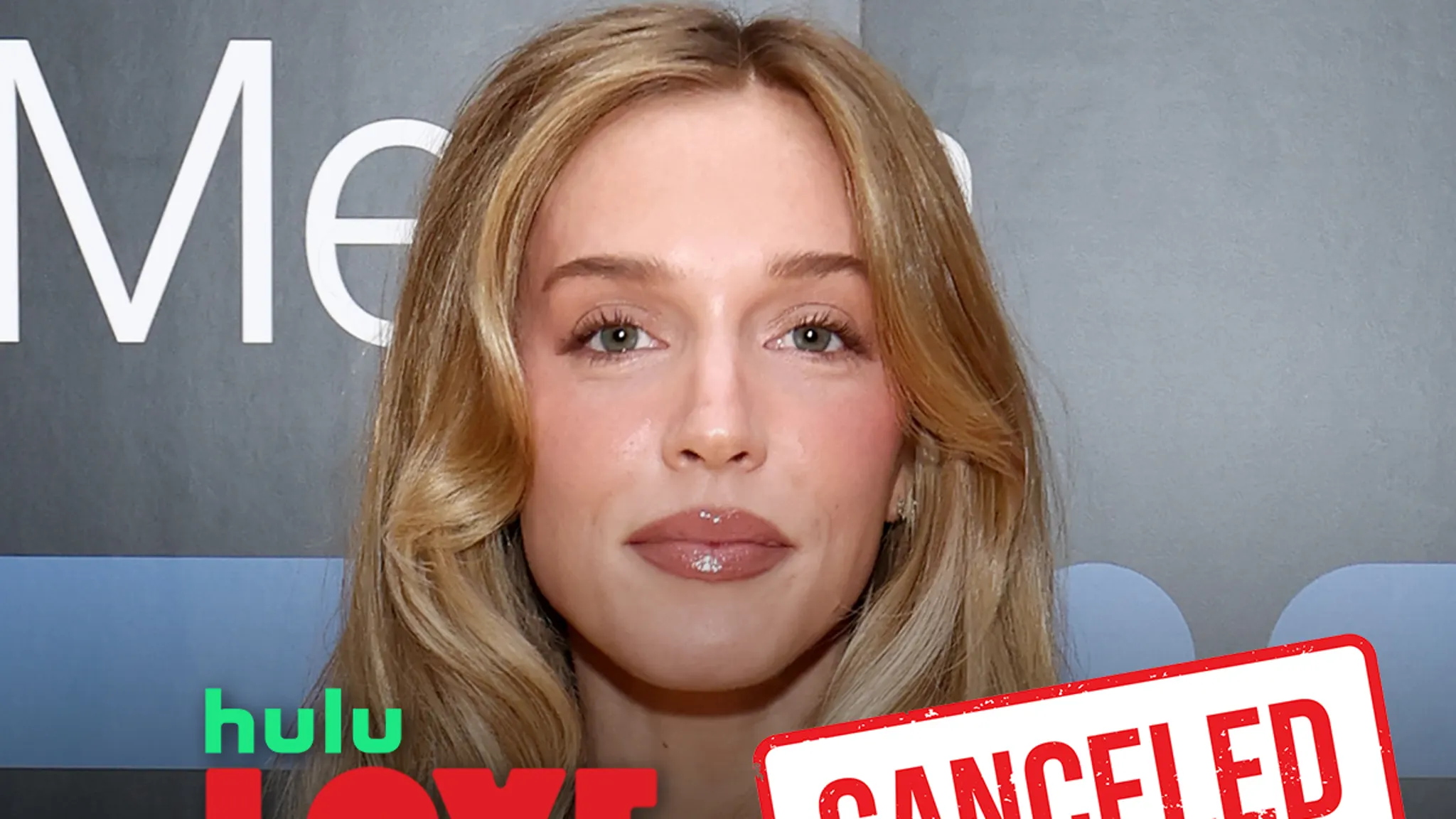 Alex Cooper posing on a red carpet at a media event