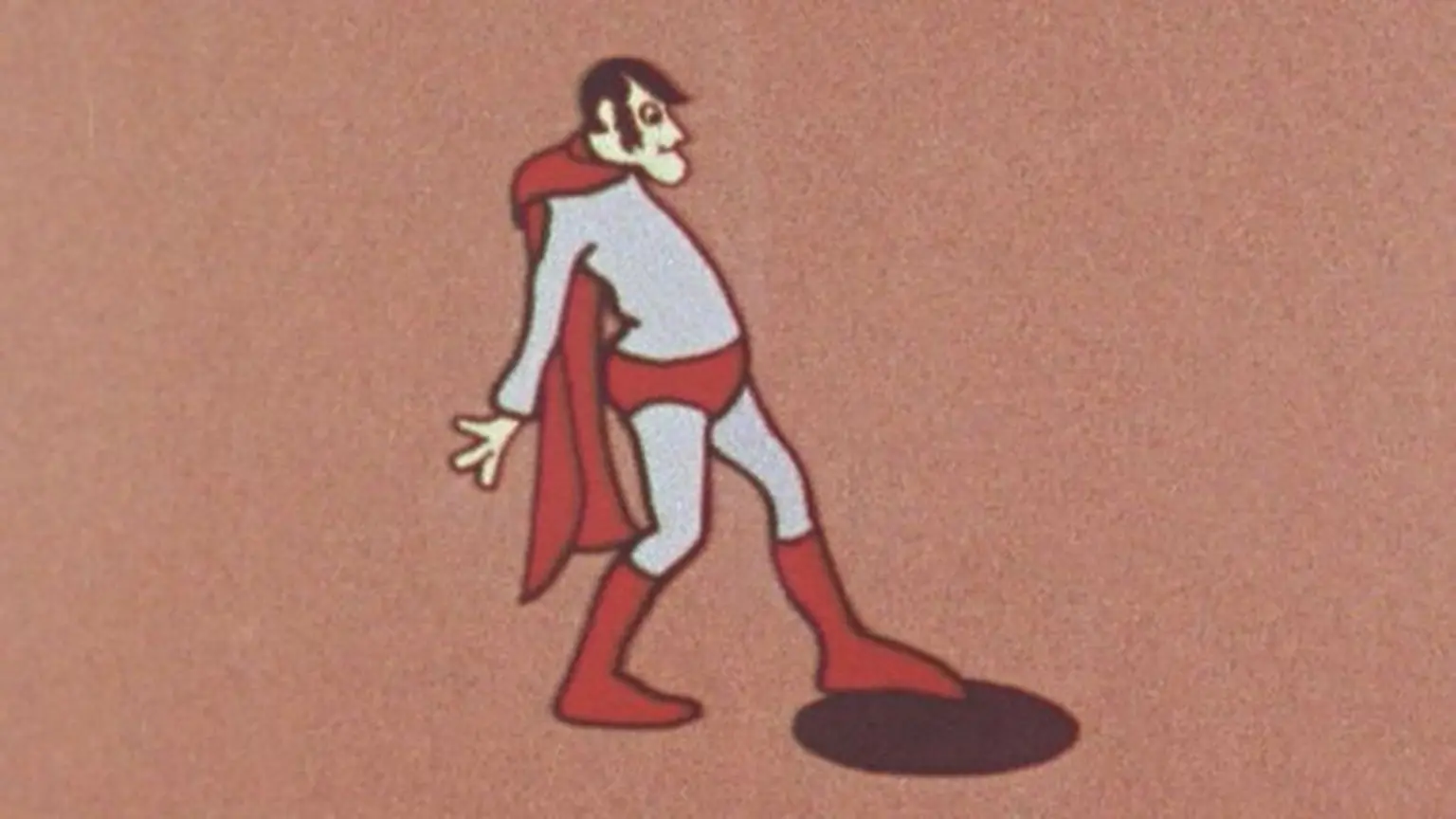 The original 'Aard Man' superhero 'dolt' that Peter Lord and Dave Sproxton created in 1972. He is wearing blue and red superhero clothes but has a sticking out belly and a strange facial expression.