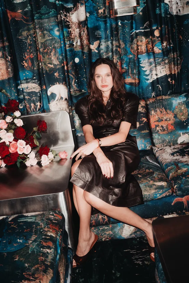 Image may contain Person Sitting Adult Clothing Sleeve Dress Face and Head