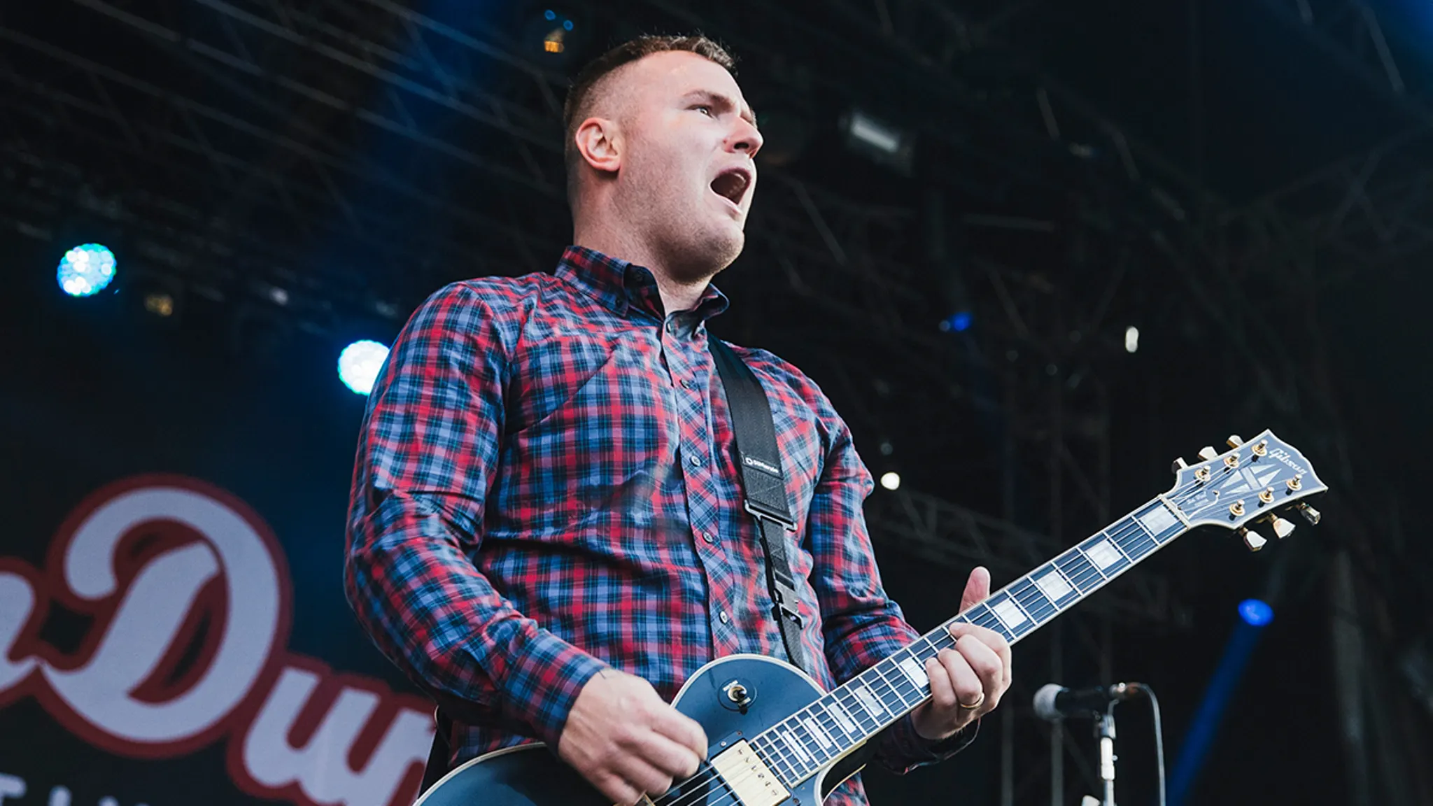 Chad Gilbert performing on stage with guitar