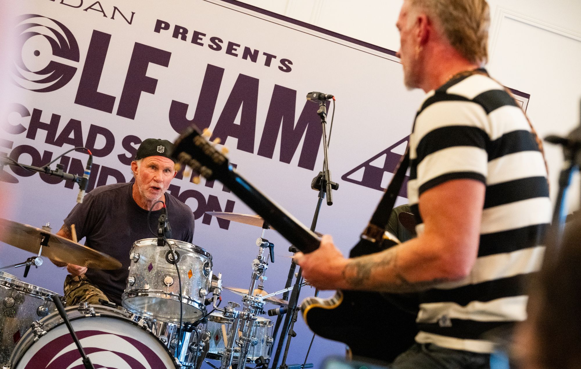 Josh Homme and Chad Smith perform together at the Golf Jam charity concert