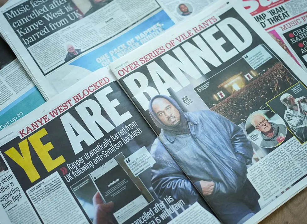 A spread of newspapers showing coverage of Kanye West being banned from entering the UK