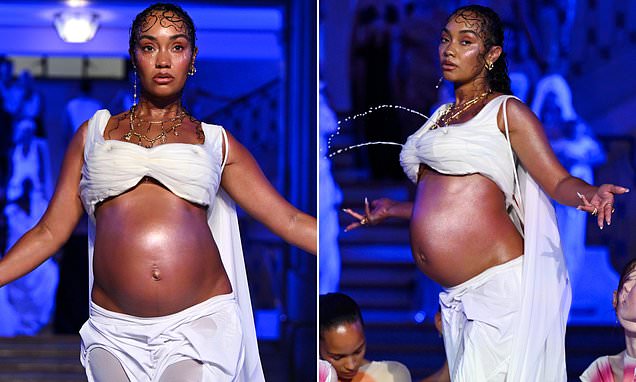 Pregnant Leigh-Anne Pinnock bares her baby bump and draws audible gasps from the crowd as her body becomes a fountain at the Di Petsa London Fashion Week show