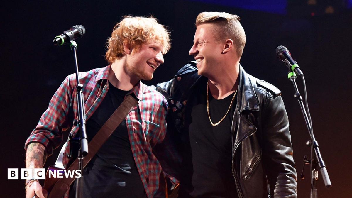 Inger/songwriter Ed Sheeran (L) and rapper Macklemore perform during the 2014 iHeartRadio Music Festival at the MGM Grand Garden Arena on September 20, 2014 in Las Vegas, Nevada. Sheeran is wearing a checked shirt and ho
