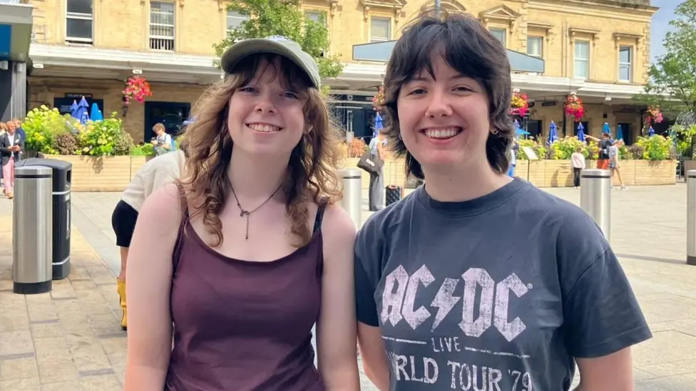 Sasha Baylors and Ciara Hornsey on their way to Reading Festival. Sasha wears a burgundy top and Ciara a grey AC/DC top.