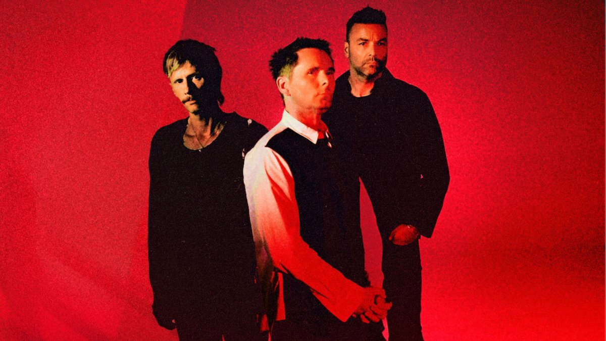 Rock band Muse performing live at a stadium concert