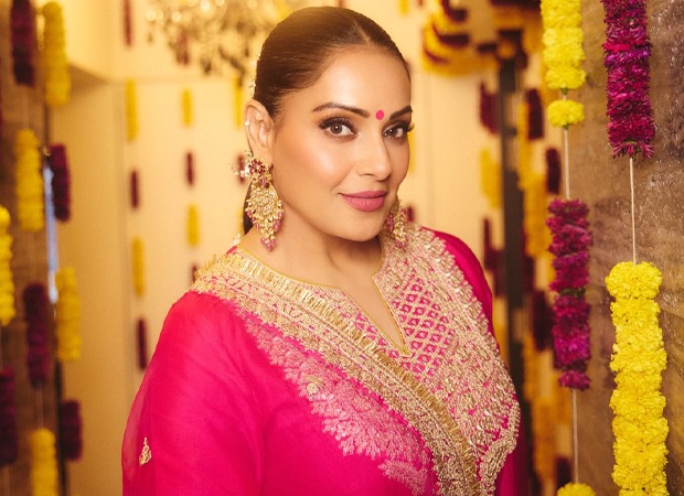 Bipasha Basu holding a protein powder tub in a video post