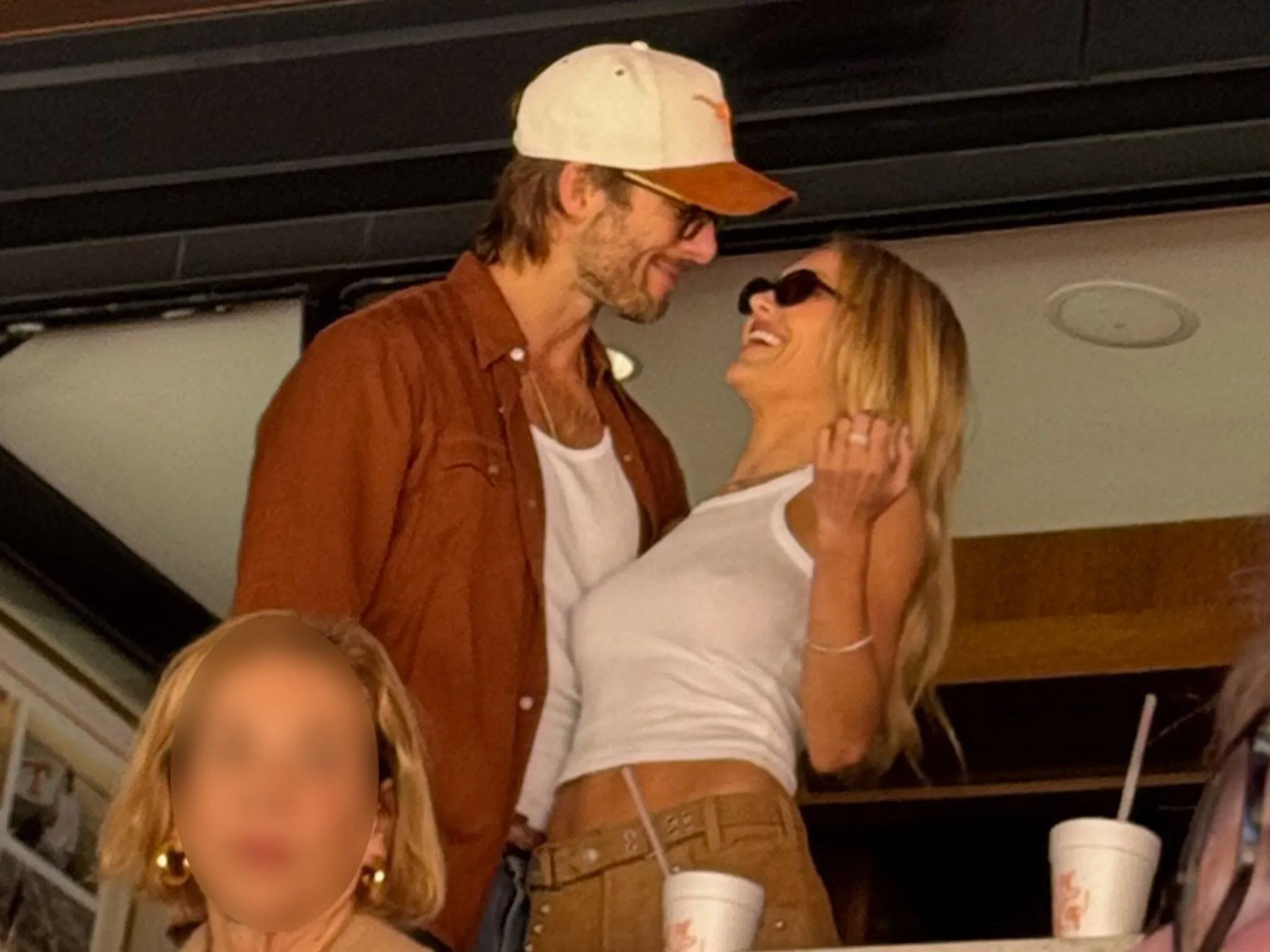 Glen Powell & Michelle Randolph All Smiles During Rare Outing At Texas-Tennessee Game