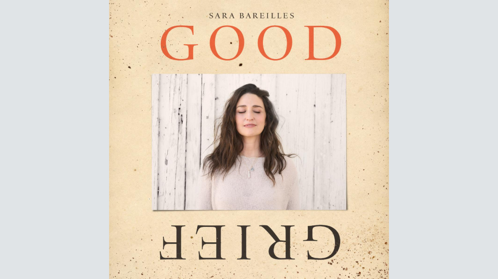 Sara Bareilles performing on stage with microphone
