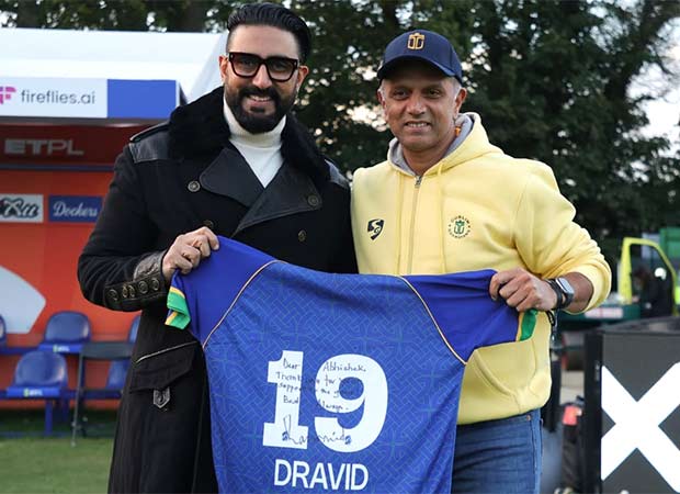 Abhishek Bachchan holding a signed Rahul Dravid cricket shirt during a tournament in Dublin
