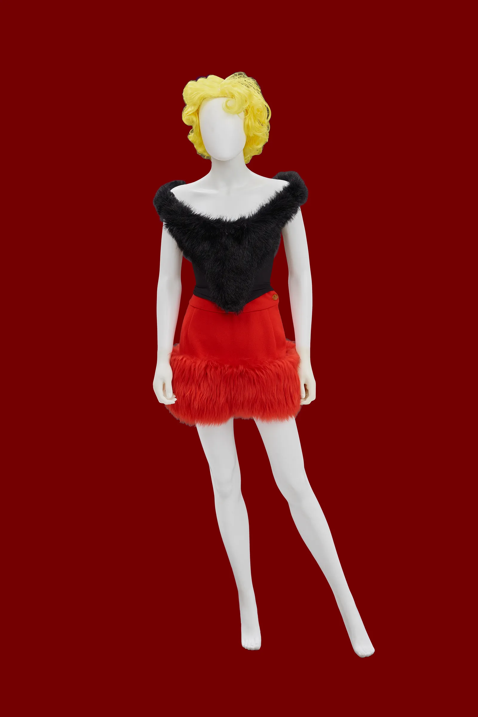 Image may contain Person Clothing Skirt Face and Head