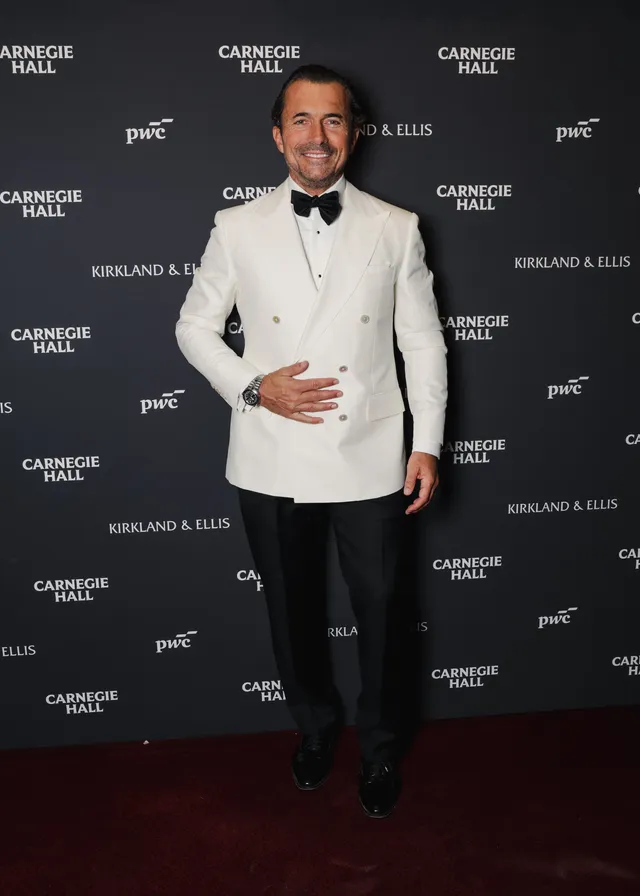 Image may contain Clothing Formal Wear Suit Tuxedo Adult Person Coat Footwear Shoe and Shirt