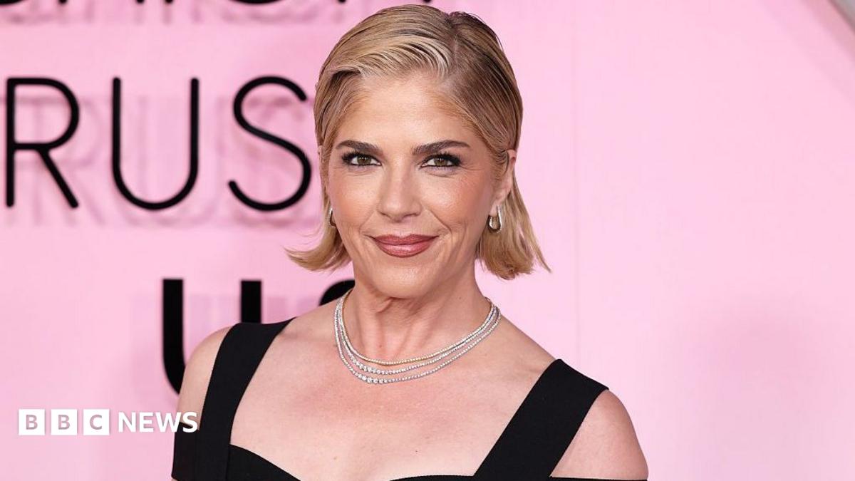 US actress Selma Blair smiles during event arrivals while wearing diamond necklaces and black strapped gown.
