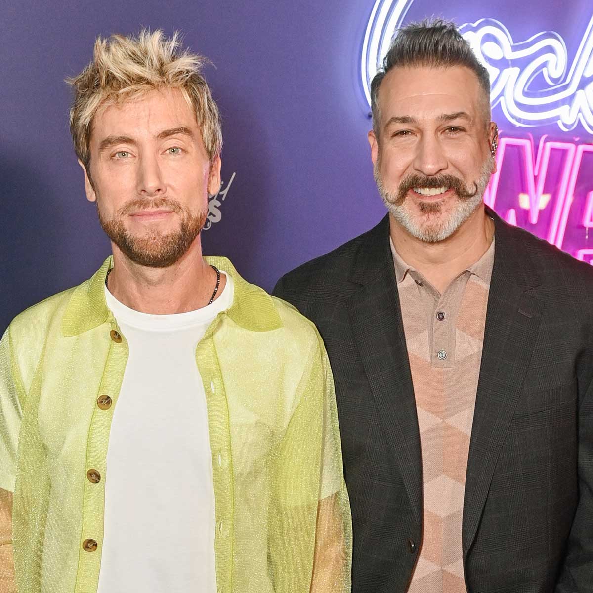 Lance Bass and Joey Fatone pose together at a red carpet event