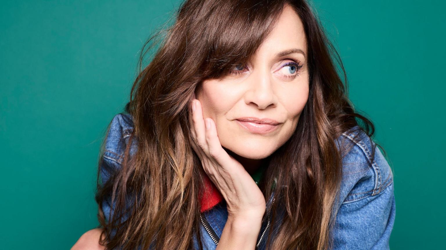 Natalie Imbruglia posing on a red carpet at a music industry event.