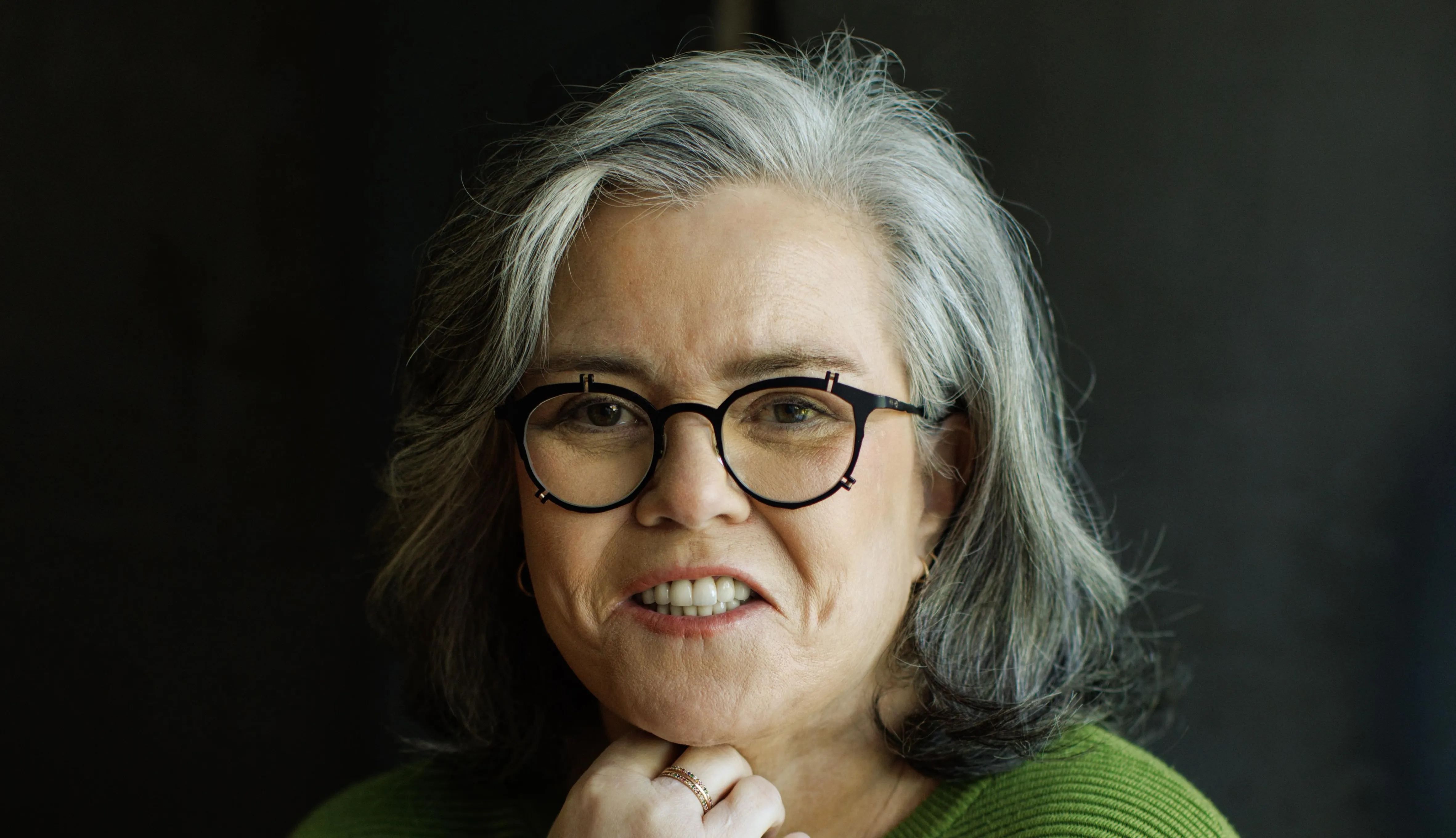 Rosie O'Donnell posing on a red carpet at a theater event