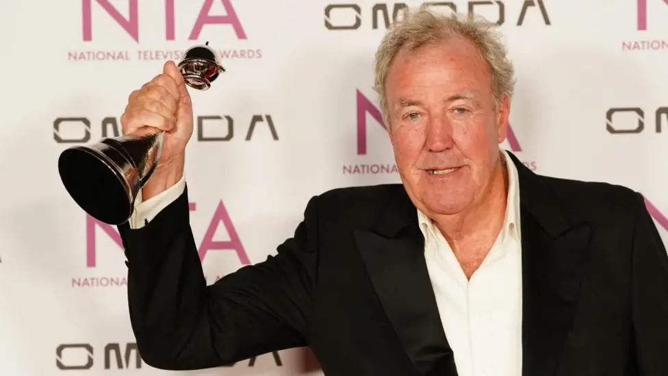 Jeremy Clarkson holding an award in the air