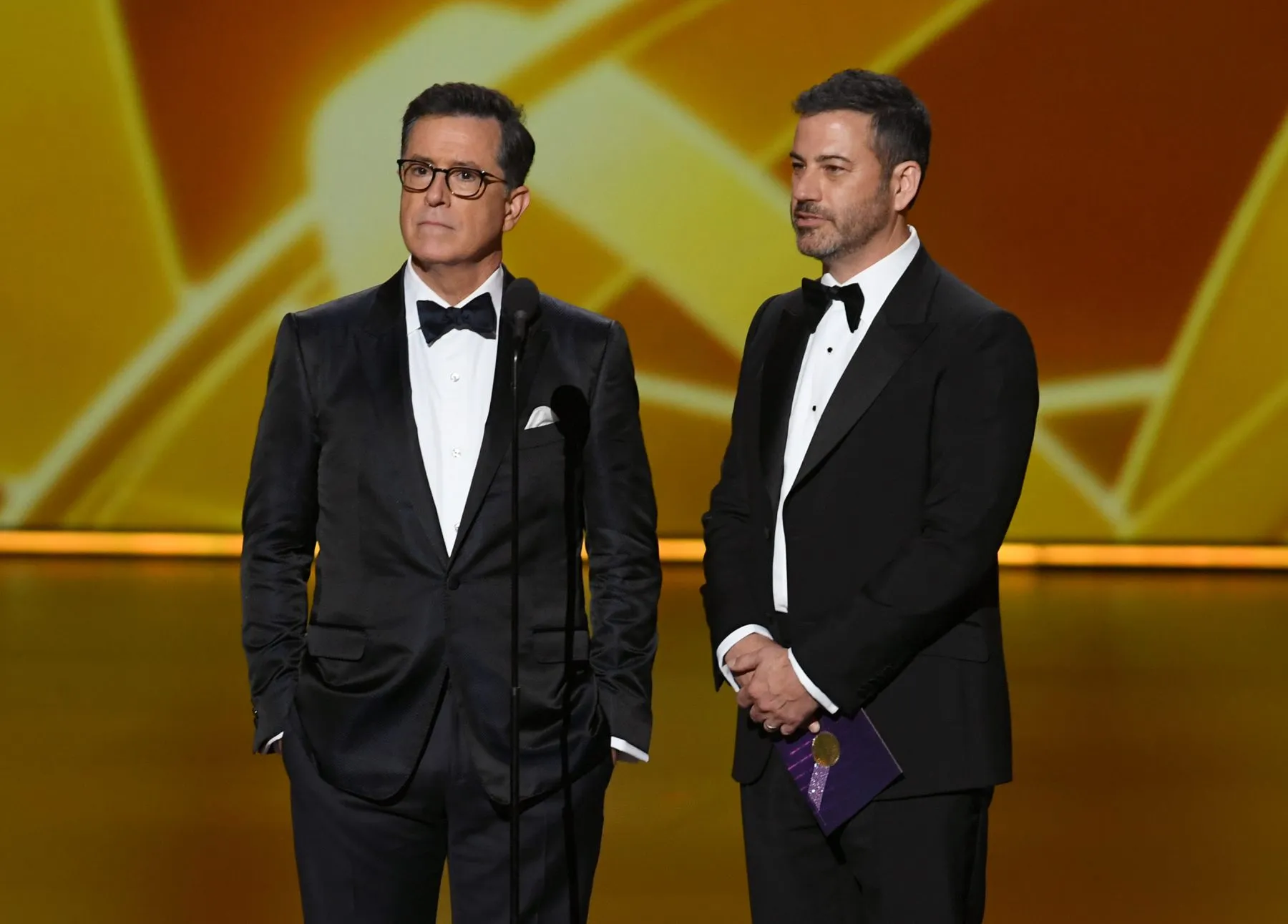 LOS ANGELES, CALIFORNIA - SEPTEMBER 22: (L-R) Stephen Colbert and Jimmy Kimmel speak onstage during the 71st Emmy Awards at Microsoft Theater on September 22, 2019 in Los Angeles, California. (Photo by Kevin Winter/