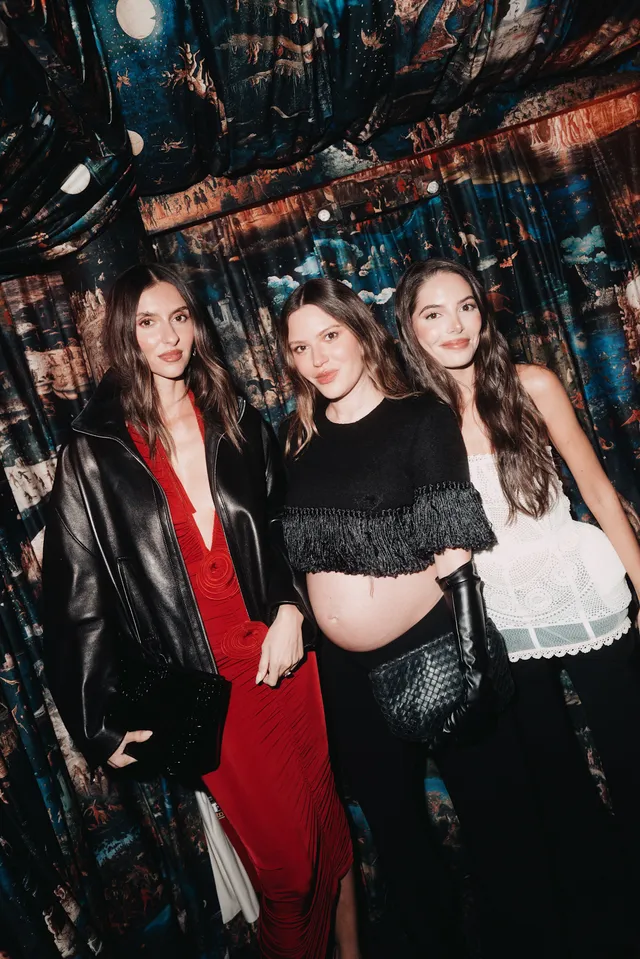 Image may contain Deniz Baysal Clothing Coat Jacket Adult Person Glove Groupshot Photobombing and Urban
