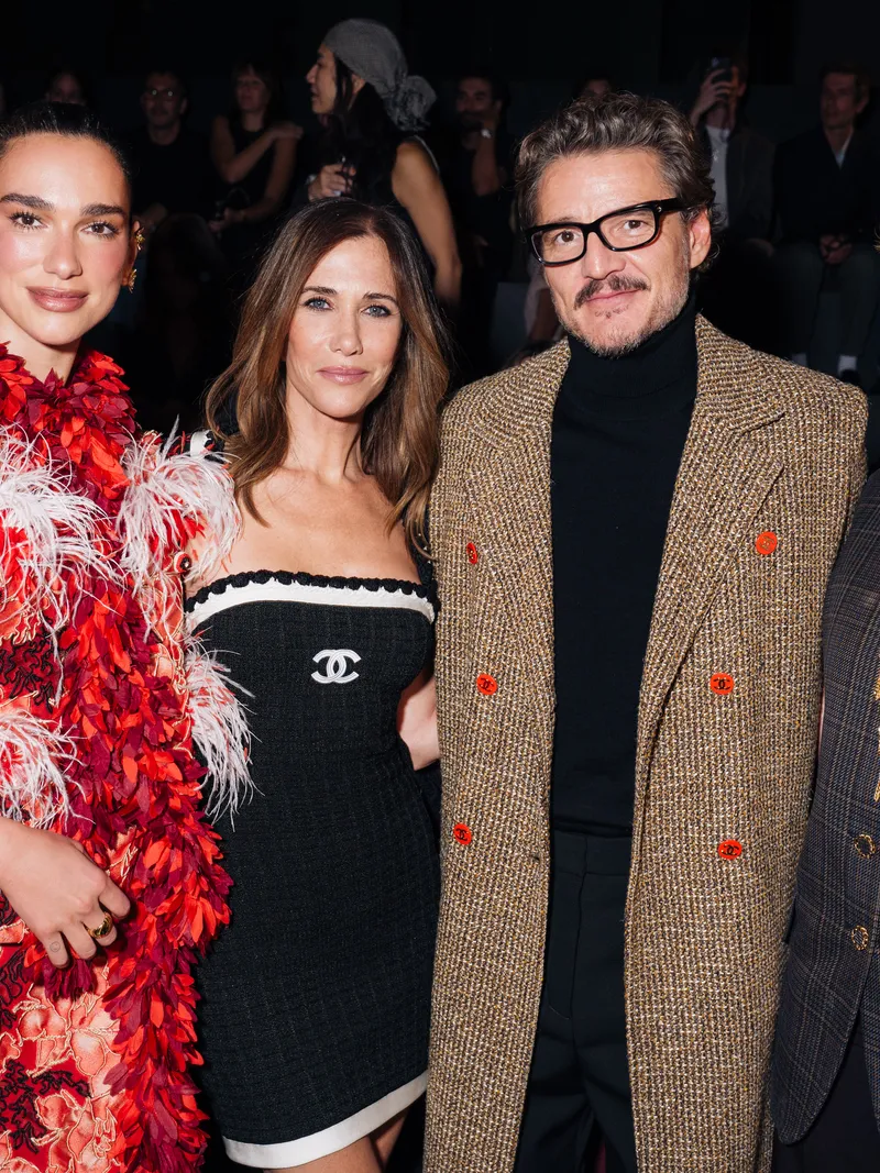 Image may contain Pedro Pascal Dua Lipa Kristen Wiig Ma Huanhuan Luz Fashion Person Photobombing Clothing and Coat