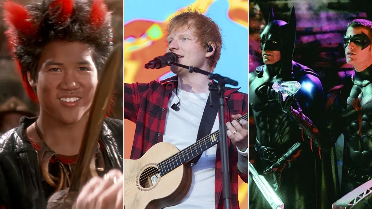 Ed Sheeran performing live on stage with his acoustic guitar