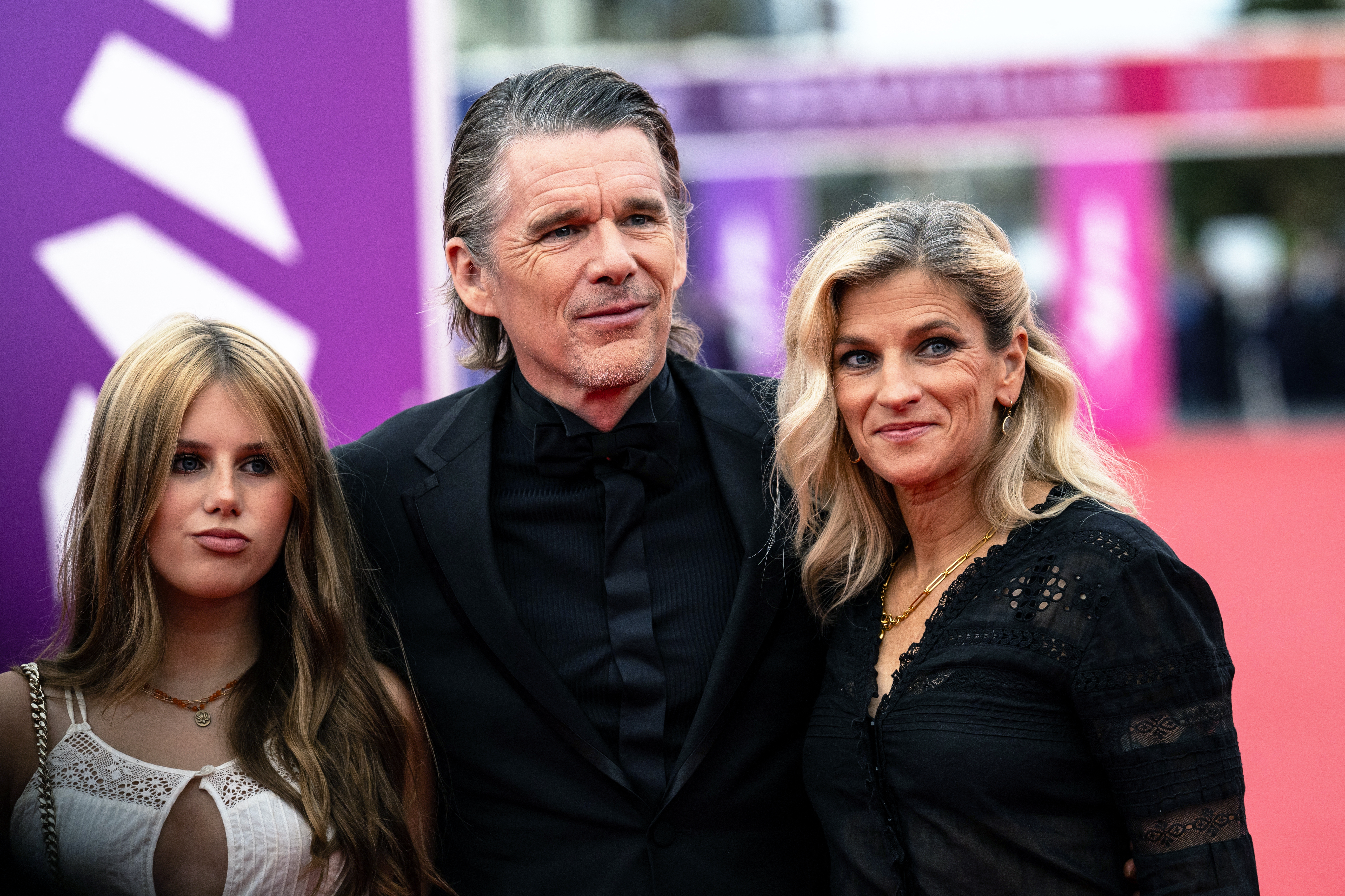 Ethan Hawke poses with his daughter Clementine Jane Hawke and wife Ryan Hawke on the red carpet.