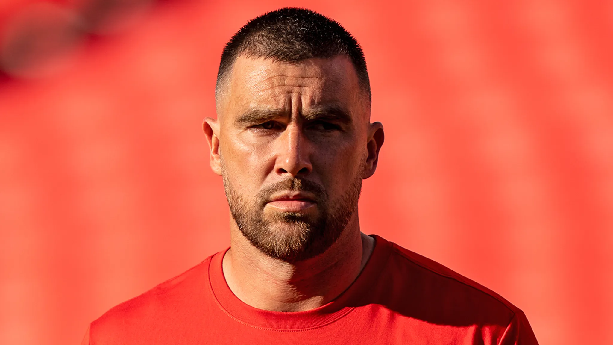 Travis Kelce attending a public event in a leather jacket