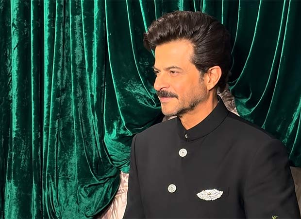 Anil Kapoor smiling on stage while hosting a television game show