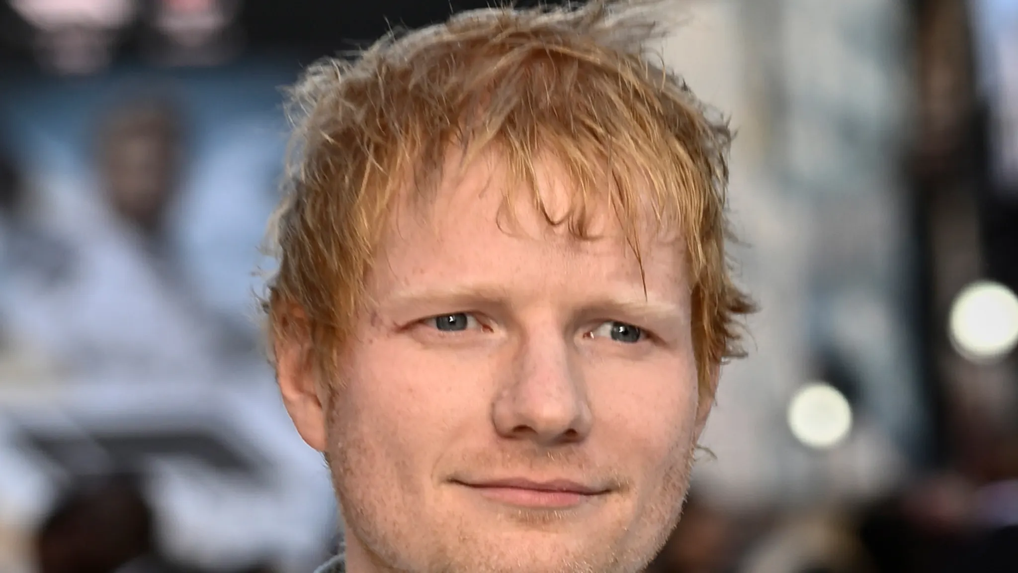 Ed Sheeran performing live on stage during his tour