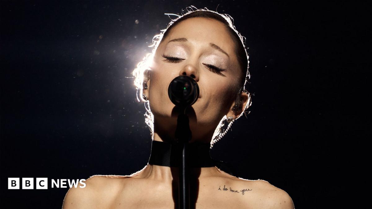 Ariana Grande singing into a microphone