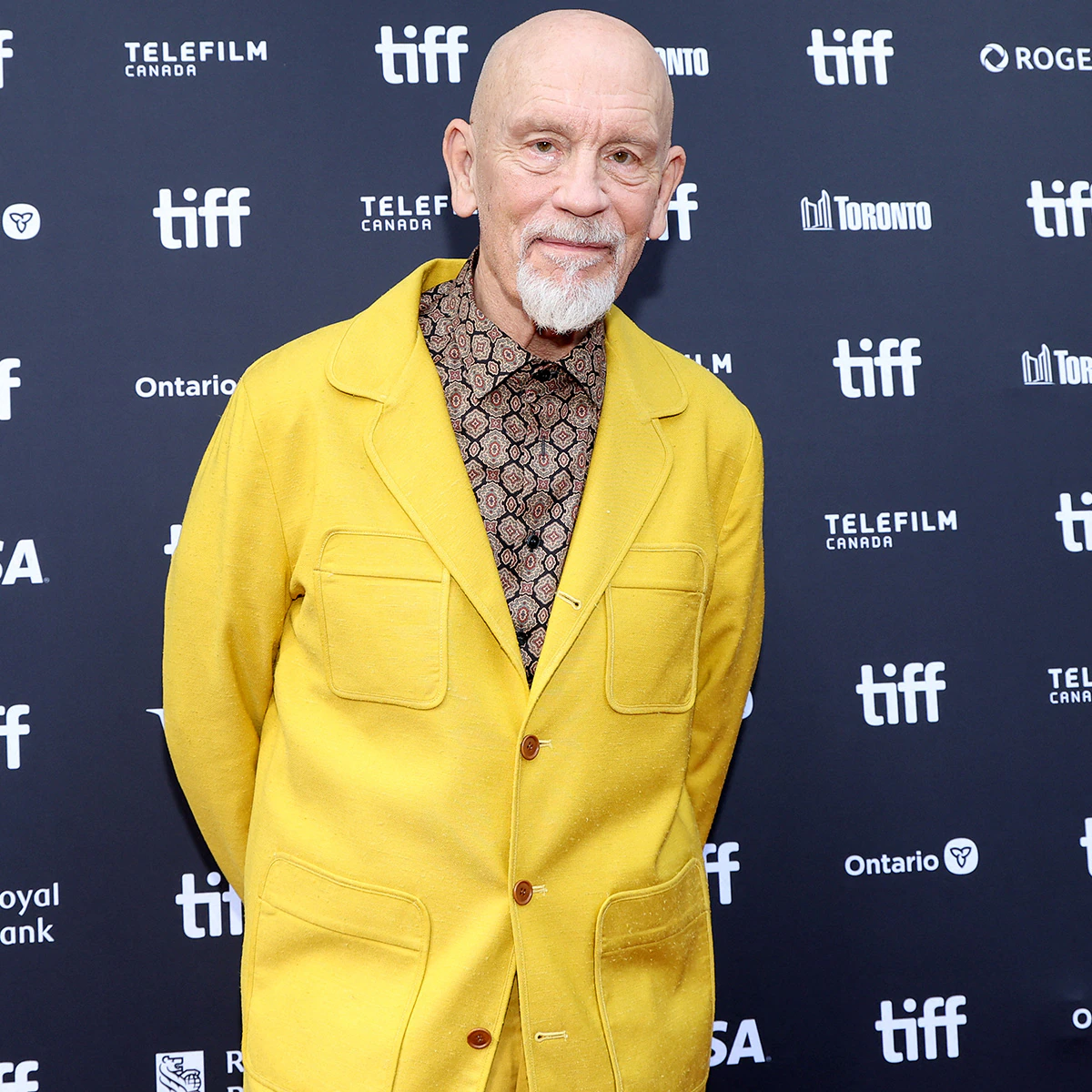John Malkovich looking calm and reflective at a public event