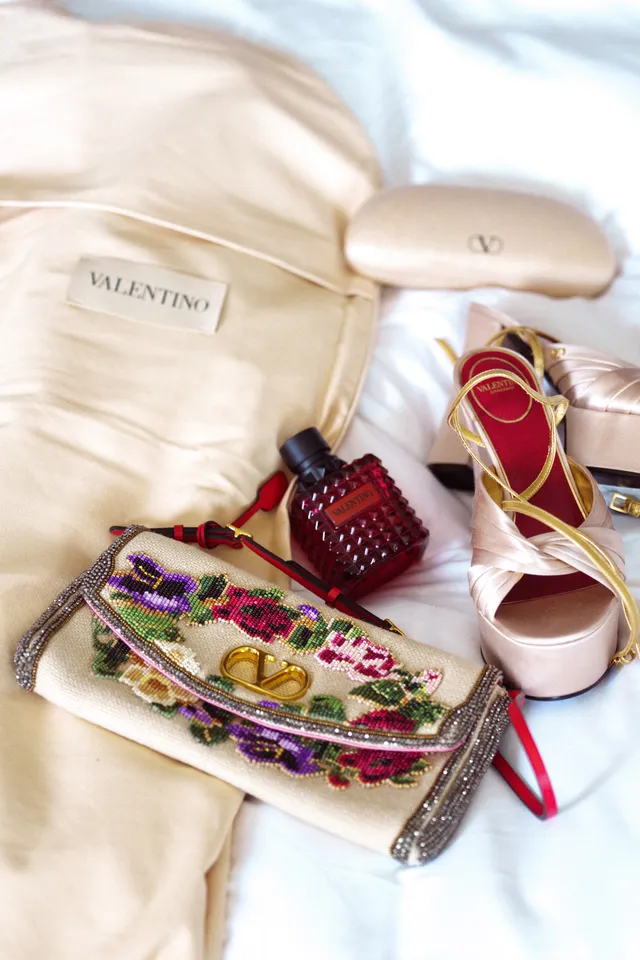 Image may contain Accessories Bag Handbag Pattern Purse Bottle Cosmetics Perfume Clothing Footwear and Sandal