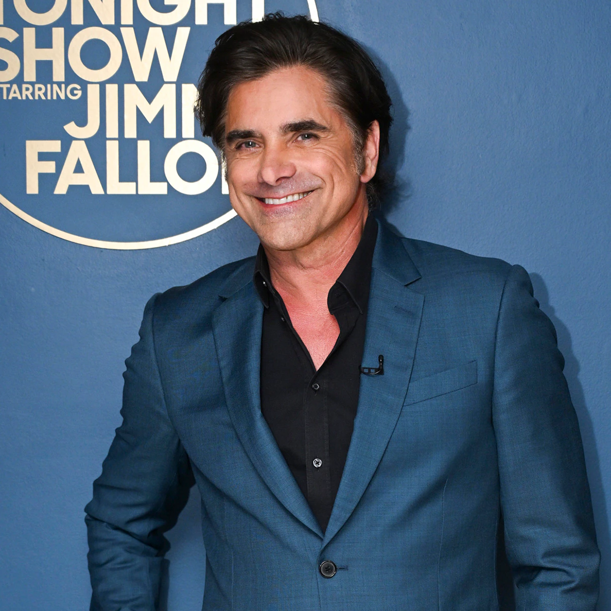 John Stamos posing for a birthday photo snapshot