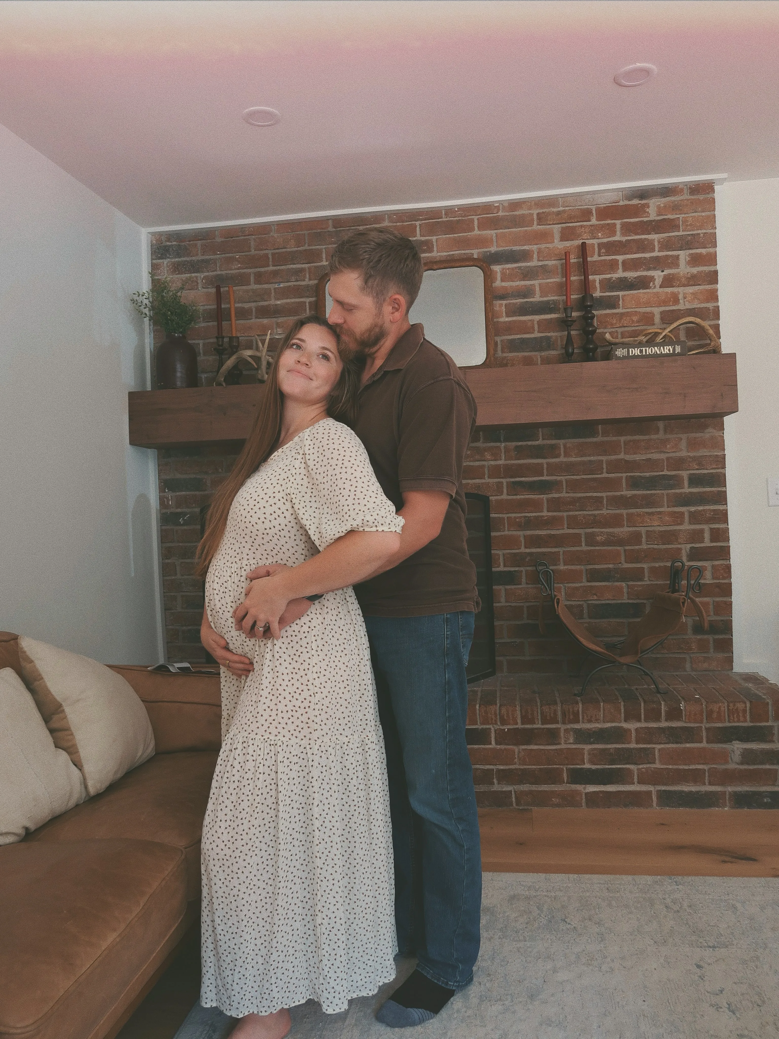 Joy-Anna Duggar and husband Austin Forsyth pose together while holding ultrasound pictures.
