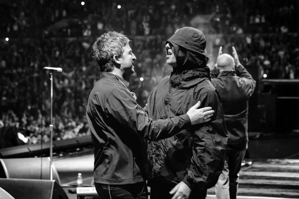 Liam and Noel (left) Gallagher enjoy a moment on stage together during their best-selling reunion tour