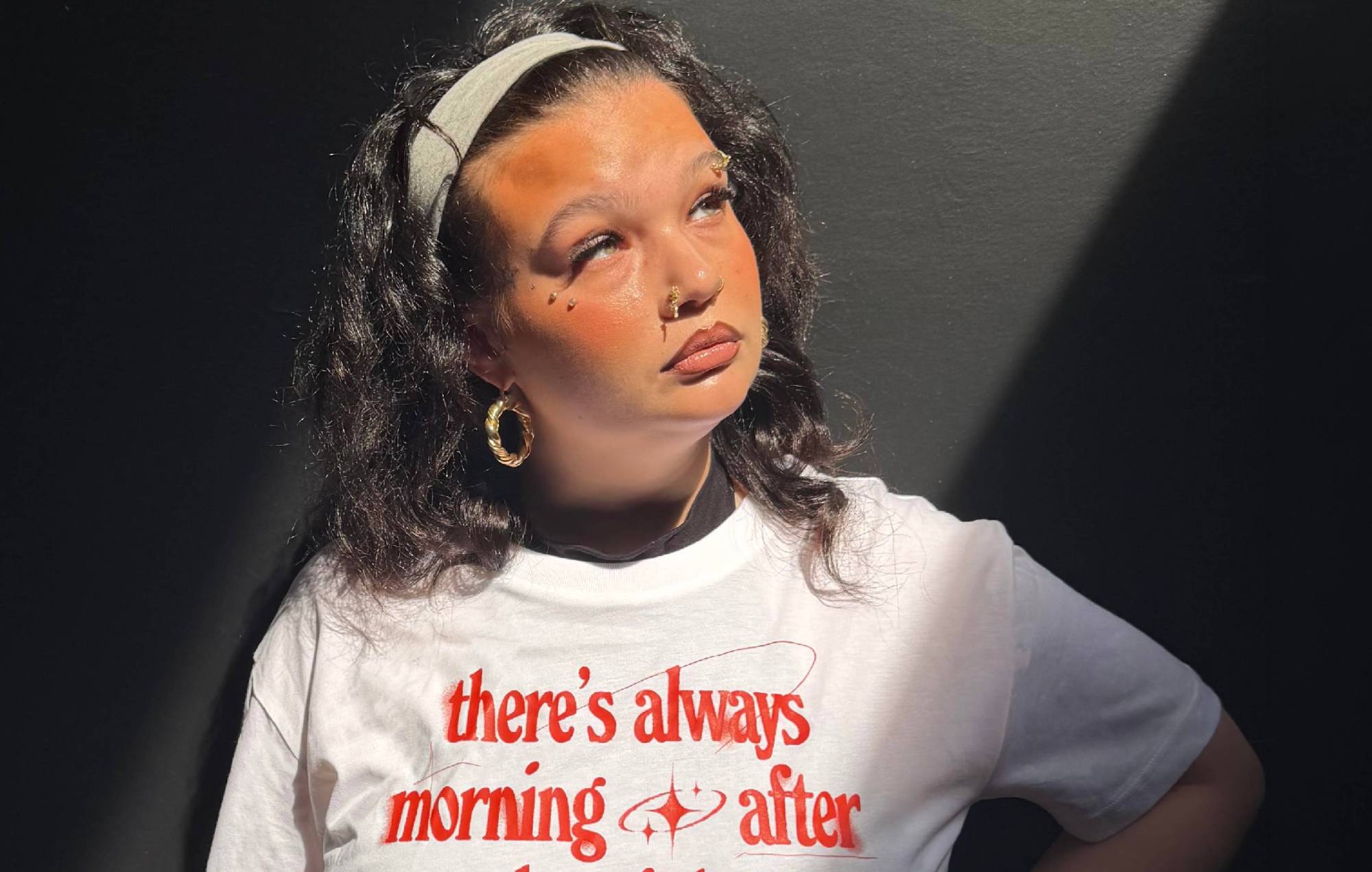 Lola Young partnering with mental health charity CALM for a suicide prevention T-shirt