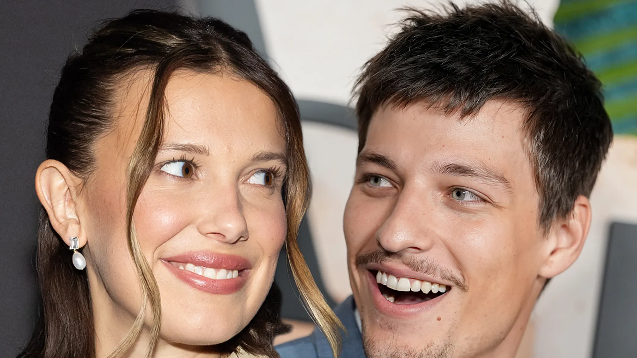 Millie Bobby Brown and Jake Bongiovi standing together at a premiere